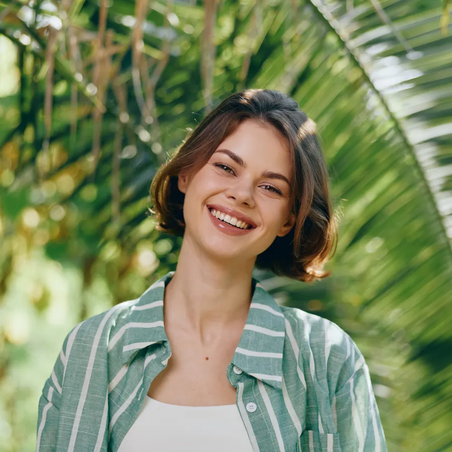 Patient with a natural, uniform smile after resin infiltration treatment